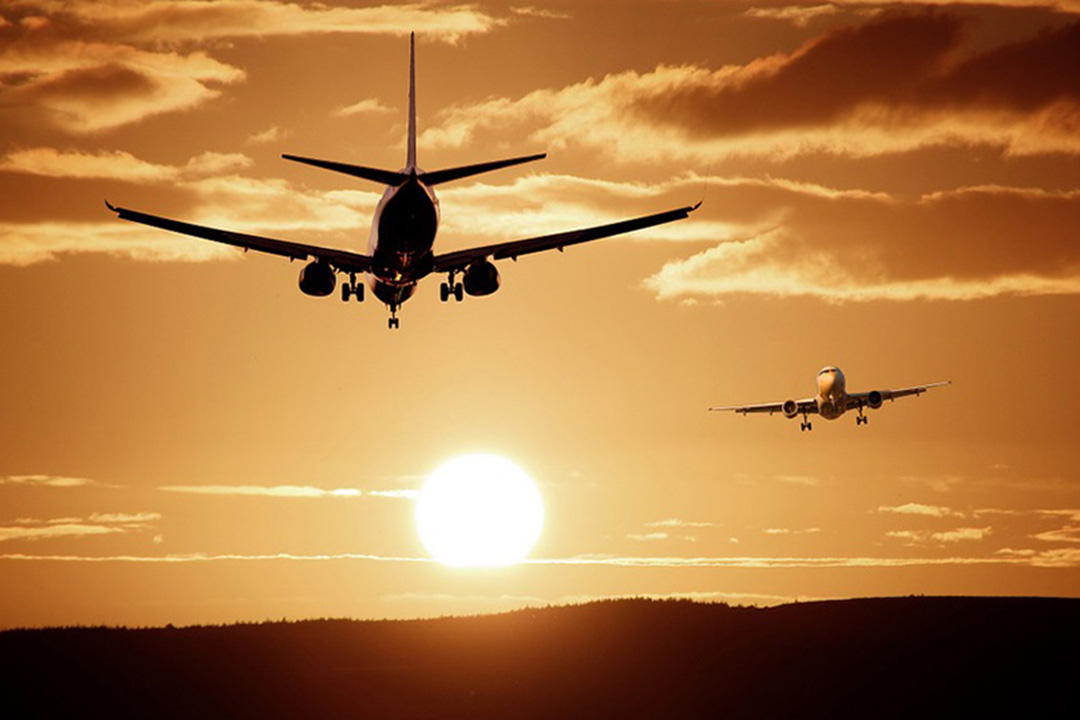 jest airliners in sunrise coloured sky